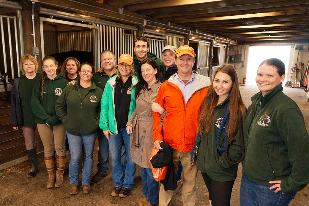 Gentle Giants staff and volunteers with Nancy Perry, Huw Collins, and ASPCA VP of Federal Affairs Richard Patch (orange jacket).