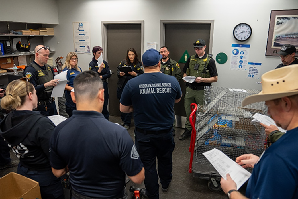 Representatives from multiple California municipalities confer at LA Animal Services before dispersing to respond to animal search and rescue calls. 