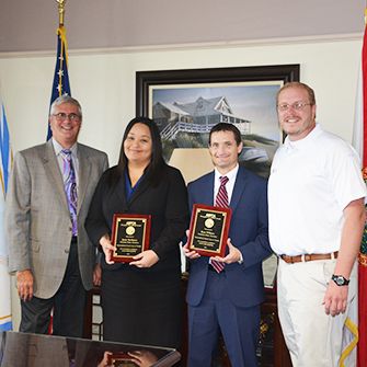 Florida assistant state attorneys Jamie McManus and Ryan Williams receive their “Champion For Animals” award.]