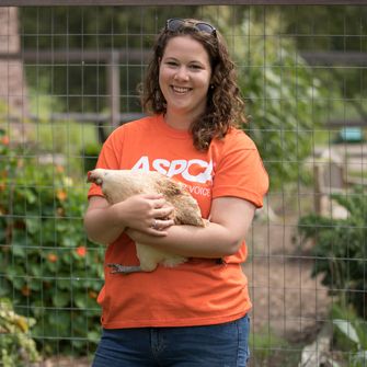 ASPCA volunteer with a chicken