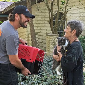 ASPCA responder E.G. Aguilar returning a cat to her pet parent